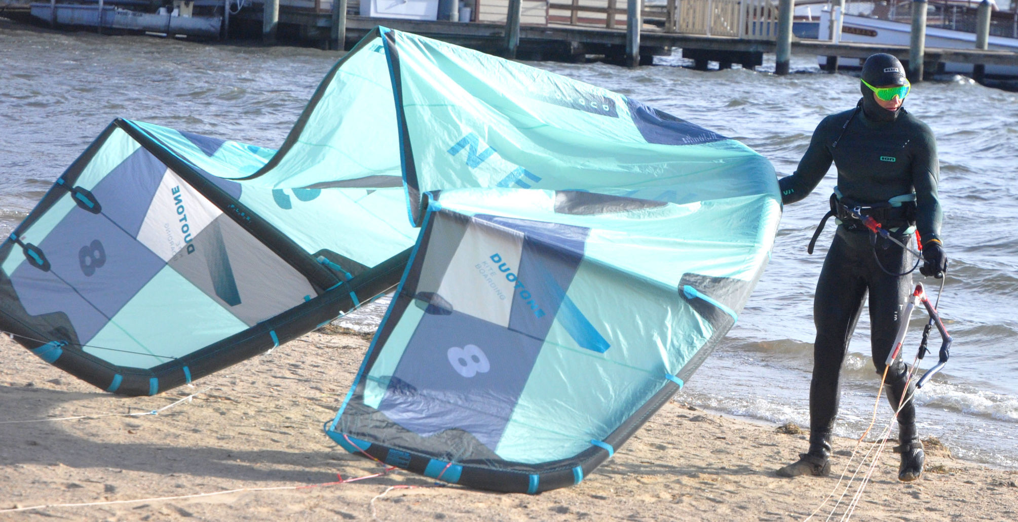 Charlie Vogel pulls in his kite boarding equipment from Geneva Lake as a he completes an afternoon of kite boarding